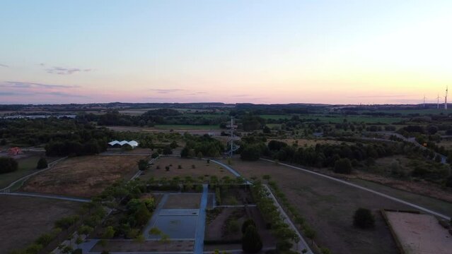 Federal horticultural show area nature. Magic aerial view flight panorama overview dronein Wismar farmland germany at sunset August 2022. 4k Cinematic