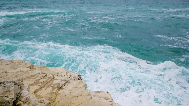Waves breaking on rt Kamenjak rocky shore, restless sea