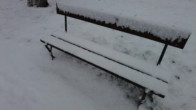 Bench in the snow on a cloudy day