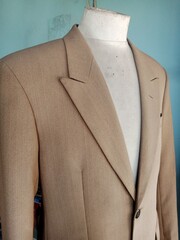 mannequin in a beige suit on a blurred background.  suitable for fashion theme