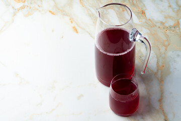 Pitcher and glass of compote on table