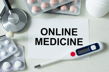 a business card in front of her with the text ONLINE MEDICINE.