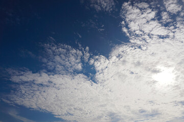 Naklejka na ściany i meble Nice clouds and sun in blue sky, Nature background