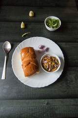 Top view of cooked food pav bhaji in a plate. 