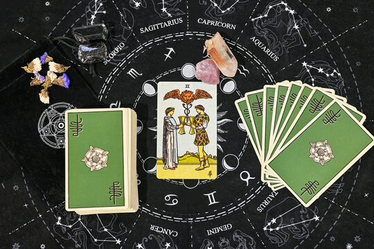 tarot spreading two of cups raider wait love reading tarot card in the middle with rose quartz and clear quartz on astrology zodiac sign constellation background