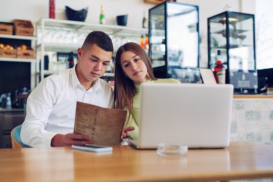 Couple looking at restaurant menu together