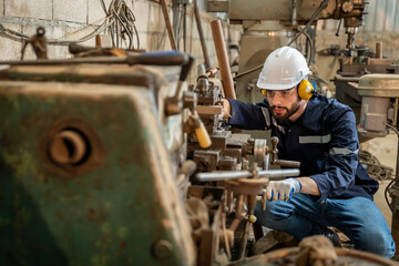 Team of engineers practicing maintenance Taking care and practicing maintenance of old machines in the factory so that they can be used continuously.