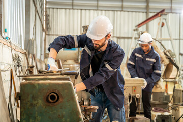 Team of engineers practicing maintenance Taking care and practicing maintenance of old machines in the factory so that they can be used continuously.