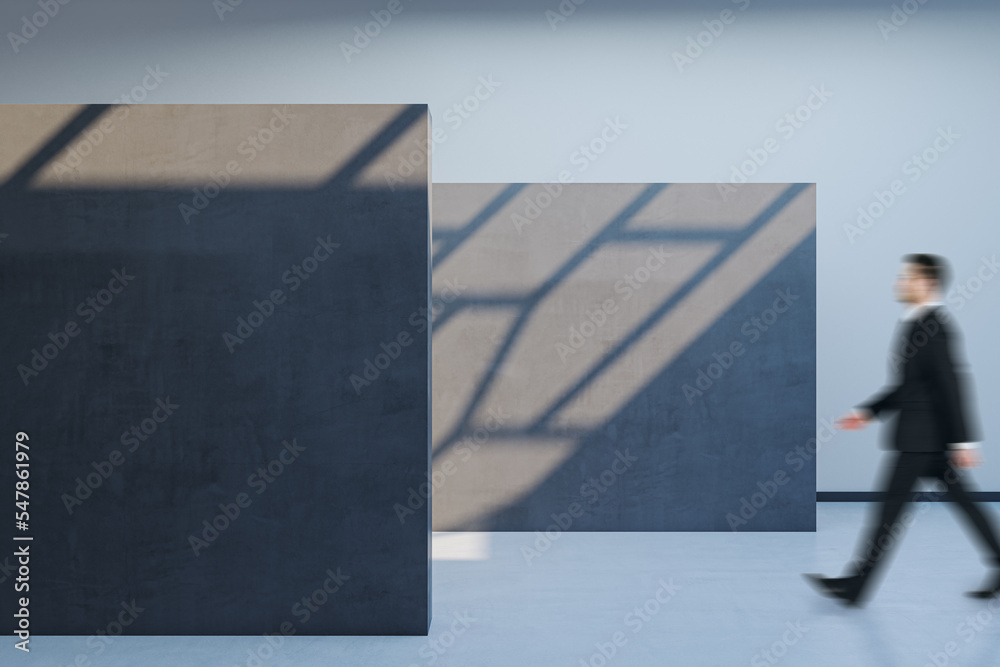 Poster side view of blurry male walking in spacious gallery interior with empty poster and sunlight shadow 
