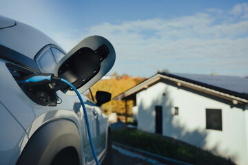 Charging an electric car in home,sustainable transportation concept.