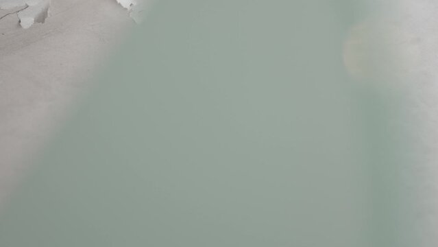 Peeling paint on bathroom ceiling rotting due to dampness and water leakage