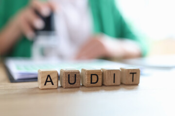 Audit word collected with wooden cubes in row