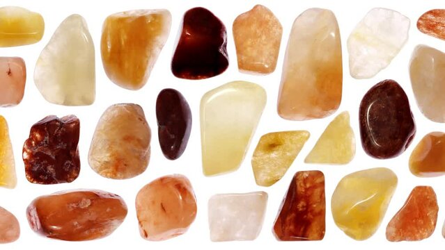 Red silk jade rare jewel stones set texture on white light isolated background. Moving right seamless loop backdrop.