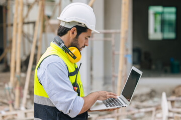 construction engineer foreman working contact with laptop computer in construction site