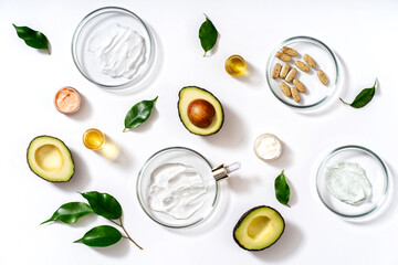 Alternative natural medicine and glass labware, petri dish, cream jars, scrub, aroma oils. Avocado...