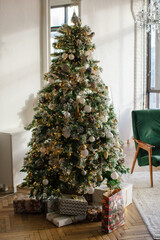 Christmas interior in retro style. White fireplace and mirror with christmas tree garland.