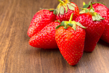 Fresh and Juicy beautiful organic strawberries on wooden background. Top view point.