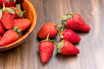 Fresh and Juicy beautiful organic strawberries on wooden background. Top view point.