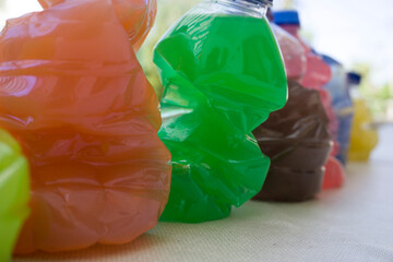 Colorful skewed bottles on nature background.