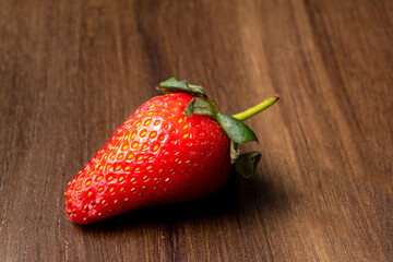 Fresh and Juicy beautiful organic strawberries on wooden background. Top view point.