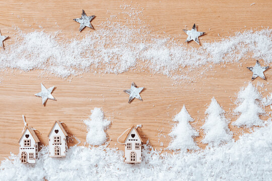 Christmas winter landscape with small houses, artificial snow, stars and trees, flat lay