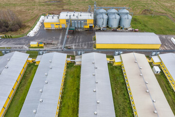 aerial panoramic view over silos and agro-industrial livestock complex on agro-processing and manufacturing plant with modern granary elevator. chicken farm. rows of chicken coop © hiv360