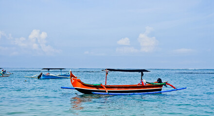 traditional wooden fishing boat on Kuta beach, Bali. Indonesia