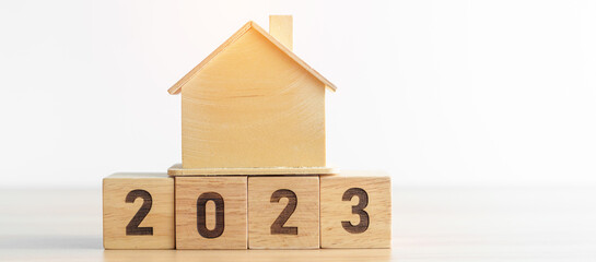 2023 block with house model. real estate, Home loan, tax, investment, financial, savings and New Year Resolution concepts