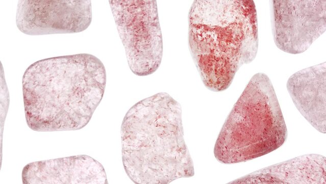 Strawberry quartz rare jewel stones texture on white light isolated background. Moving right seamless loop backdrop.