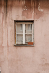 Pink coral wall and wooden window. Traditional European old town building. Old historic architecture in Nuremberg, Germany