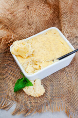 Sago or Tapioca pudding in square bowl on rustic burlap surface
