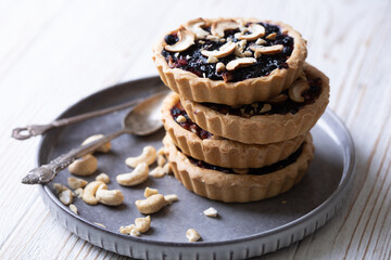 tartlets with apple jam and blueberry confiture