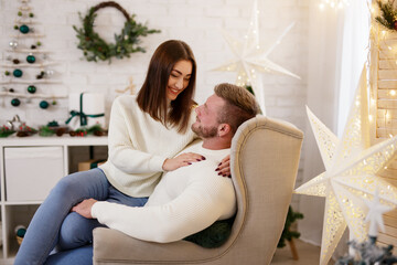 Happy man and woman in christmas decorated room