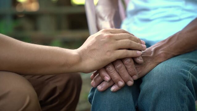 Hands of the old man and a man hand. encouragement,.