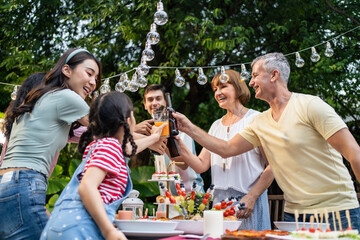 Multi-ethnic big family having fun, enjoy party outdoors in the garden. 