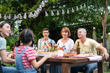 Multi-ethnic big family having fun, enjoy party outdoors in the garden. 