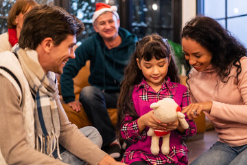 Caucasian family exchanging presents during Christmas party at home.