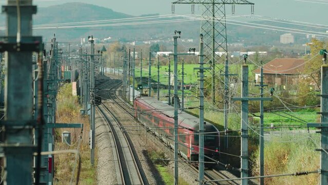 A high-speed Train running through an industrial area in Austria