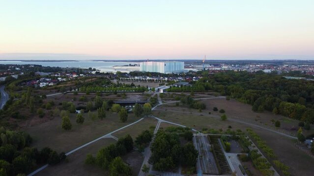 Shipyards Wismar at the Port Baltic Sea. Great aerial view flight panorama overview drone static tripod hovering drone
in Wismar farmland germany at sunset August 2022. Marnitz 4k Cinematic
