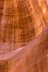 The Siq, narrow red canyon wall texture background in Petra, Jordan, UNESCO World Heritage Site