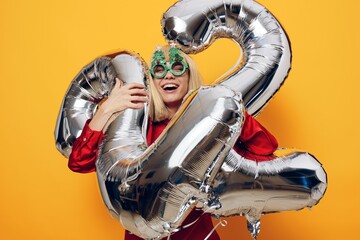 horizontal photo on a bright background of a happy, emotional woman in funny holiday glasses...