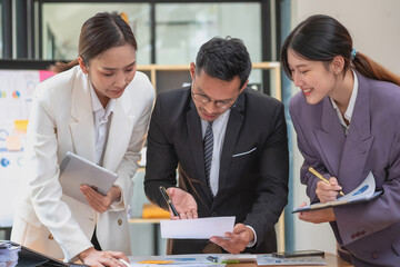 Marketing, Finance, Accounting, Planning, A team of businessmen plan with their laptops and graph charts for their profits and use a calculator to calculate their company is annual balance.