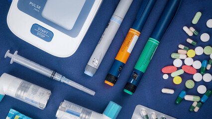 Picture of medical drugs pills, sryinge, insulin pen, automatic blood presure monitor device and...