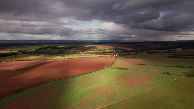 Aer ial view of a German village surrounded by meadows, farmland and forest in Germany.