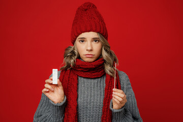 Young sad woman wear grey sweater scarf hat do coronavirus covid-19 test look camera isolated on...