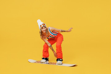 Snowboarder fun happy woman wear orange ski suit goggles mask hat swimsuit spend extreme weekend...