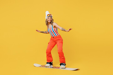 Snowboarder happy smiling fun woman wear orange ski suit goggles mask hat swimsuit spend extreme...
