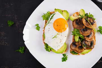 Sandwiches  with avocado, fried egg and mushrooms  for healthy breakfast or snack. Top view, above