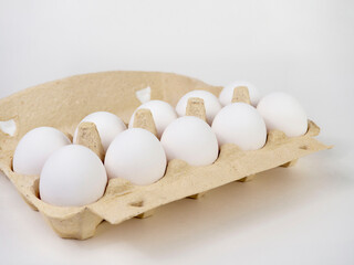 White eggs in a box on a light background. Food crisis. Declining supply of eggs in Britain.
