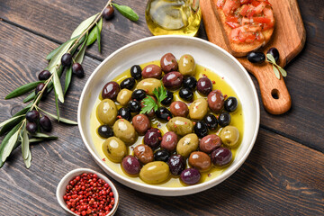Mixed green olives and black olives with olive oil, healthy eating antioxidants